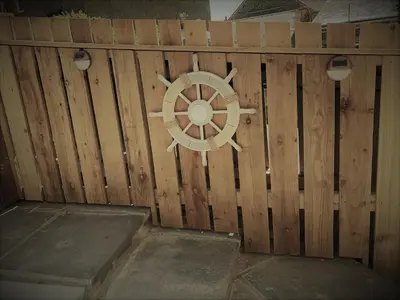a wooden fence with a wheel on it at Hawen - Barmouth in Barmouth