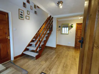 a room with a wooden staircase in a house at Nant Gloyw Oswestry in Oswestry