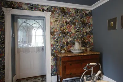 a room with a floral wallpaper on the wall at Plas Esgair in Llanbrynmair