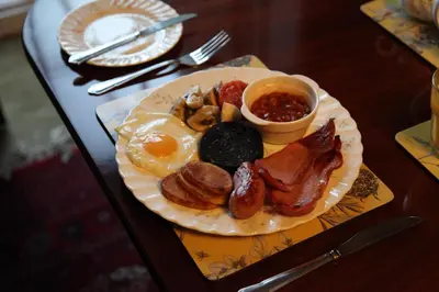 a plate of breakfast food on a table at Plas Esgair in Llanbrynmair