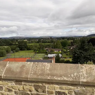 a view of a city from a stone wall at Lucea Cottage in Craven Arms