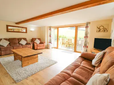 a living room with a couch and a table at The Stables in Knighton