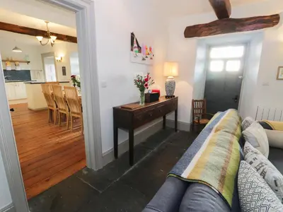 a living room with a couch and a table at Goronwy Cottage in Barmouth