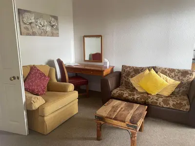 a living room with a couch and a table at Highland Moors in Llandrindod Wells