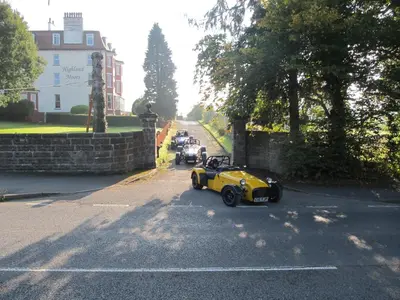 a yellow car parked on the side of a road at Highland Moors in Llandrindod Wells