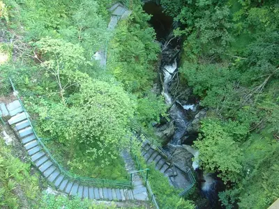 an overhead view of a waterfall and stairs next to a river at Highland Moors in Llandrindod Wells