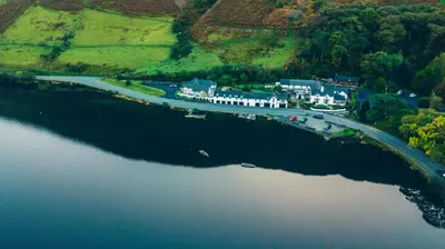an aerial view of a house and a river at Tynycornel Hotel in Tal-y-llyn