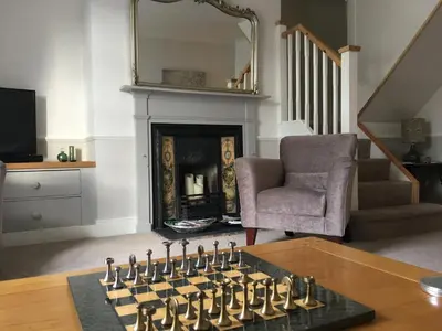 a living room with a chess board in front of a fireplace at Beautiful stylish 2 bed apartment with free parking in Ludlow