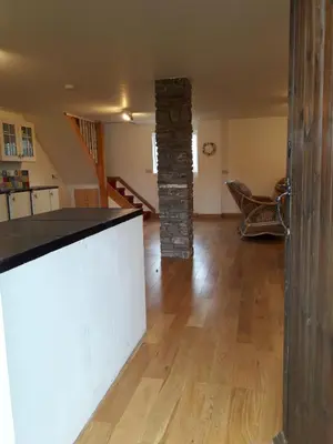 a kitchen and living room with a stone pillar at The Barn Annexe, Cefn-Yr-Allt in Crickadarn