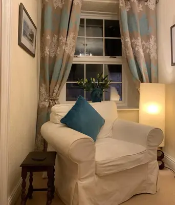 a living room with a white couch and a window at Evangelisa in Lampeter