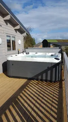 a hot tub on the deck of a house at Ruth's Retreat Beautiful Country Retreat with private hot tub & wonderful views in Shrewsbury