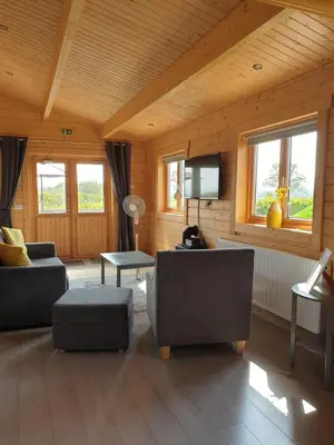 a living room with couches and a flat screen tv at Ruth's Retreat Beautiful Country Retreat with private hot tub & wonderful views in Shrewsbury