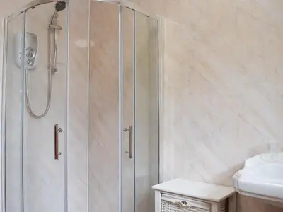 a shower with a glass door in a bathroom at Glasfor in Llanon