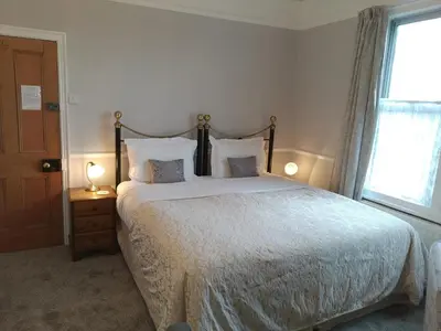 a bedroom with a large bed and a window at Anton Guest House Bed and Breakfast in Shrewsbury