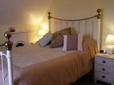 a bedroom with a large bed with a white headboard at Anton Guest House Bed and Breakfast in Shrewsbury