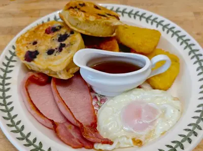a plate of breakfast food with eggs bacon and toast at Anton Guest House Bed and Breakfast in Shrewsbury