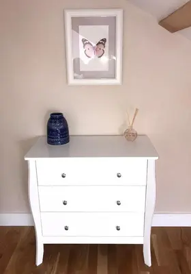 a white dresser in a room with a picture on the wall at Apartment 4, 1 Laura Place in Aberystwyth
