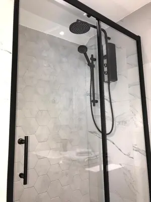 a shower with a glass door in a bathroom at Apartment 4, 1 Laura Place in Aberystwyth