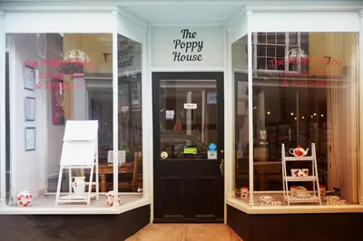 a store front of a happy house with a black door at The Poppy House in Bishops Castle