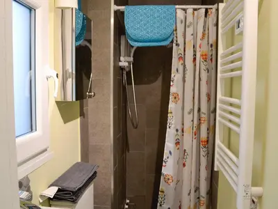 a shower with a shower curtain in a bathroom at Tŷ Ar Y Tro in Tanygrisiau