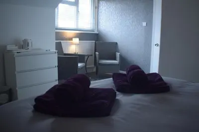 a bedroom with purple pillows on a bed at Borthwenbnb in Dolgellau