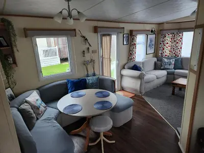 a living room with a couch and a table at 92 Barmouth Bay Holiday Park in Llanddwywe