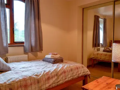 a bedroom with a bed and a mirror at Bryn Villa in Newbridge on Wye