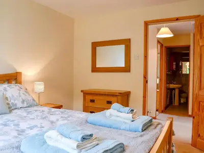a bedroom with a bed with towels on it at Bryn Villa in Newbridge on Wye