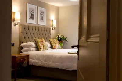 a bedroom with a bed with two pillows on it at Royal Ship in Dolgellau