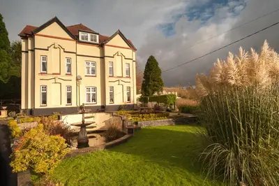a large house with a garden in front of it at Ardwyn House in Llanwrtyd Wells