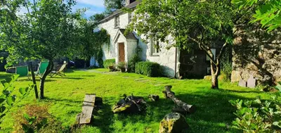 a yard of a house with a bench in the grass at Gesail Barn and Farmhouse in Machynlleth