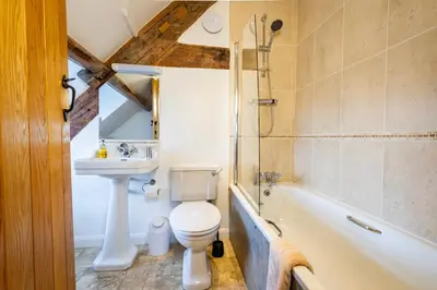 a bathroom with a toilet and a sink and a bath tub at Ty Newydd B&B in Brecon