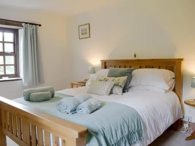 a bedroom with a large bed with towels on it at The Oak in Newchurch