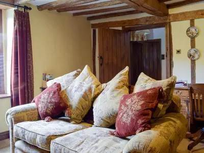 a couch with pillows on it in a living room at The Oak in Newchurch