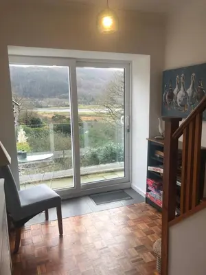 a living room with a large window with a view at Snowdonia Mawddach escape in Dolgellau