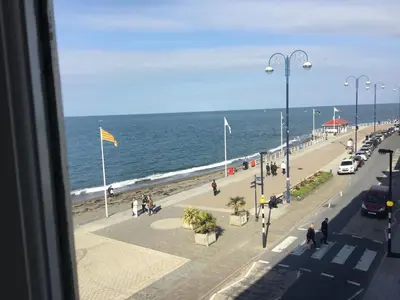 a view of the beach from a window at Helmsman Guesthouse in Aberystwyth
