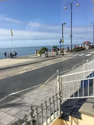 an empty street with the ocean in the background at Helmsman Guesthouse in Aberystwyth