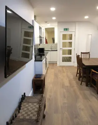 a kitchen and dining room with a table and chairs at 3 Park View in Barmouth