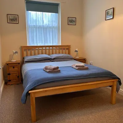 a bedroom with a bed with two towels on it at 2 Bell Street in Talgarth