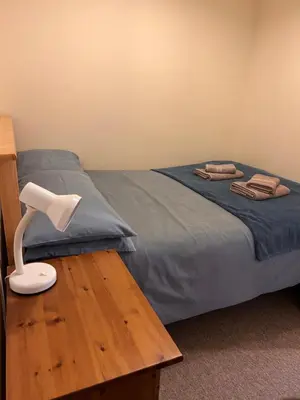a bedroom with a bed and a lamp on a table at 2 Bell Street in Talgarth