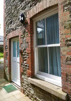 a brick building with two windows on it at 2 Bell Street in Talgarth