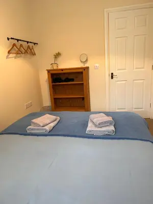 a bedroom with a bed with two towels on it at 2 Bell Street in Talgarth