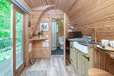 a kitchen in a tiny house with a sink at Nyth Y Goedwig in Dolgellau