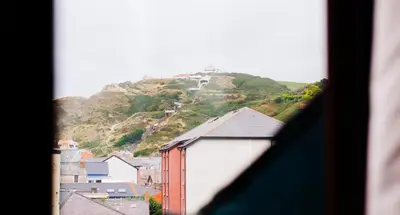 a view from a window of a town with a mountain at Rooms by Maes y mor Town Centre in Aberystwyth