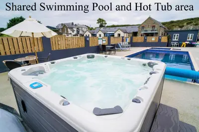 a swimming pool and a hot tub in a backyard at The Stores in Aberystwyth