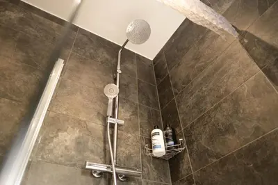 a shower with a shower head in a bathroom at Rose Cottage in Shrewsbury