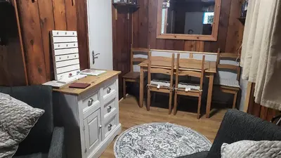 a bedroom with a table and a dining room at Indigo Lodge - Aberdovey in Aberdyfi
