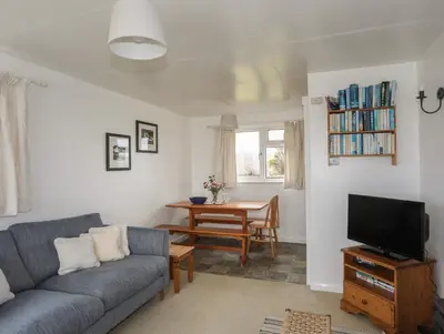 a living room with a couch and a table at Allt y Mor in Harlech