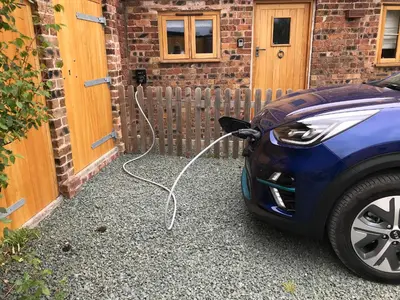 a electric car is parked outside of a house at The Tractor Shed in Oswestry