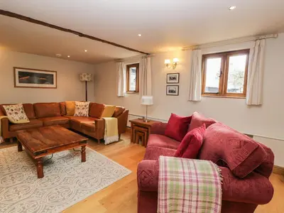 a living room with a couch and a table at The Old Barn in Hereford